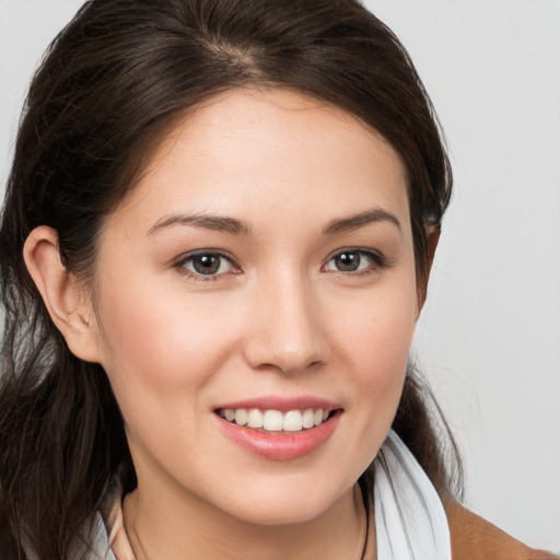 Joyful white young-adult female with medium  brown hair and brown eyes