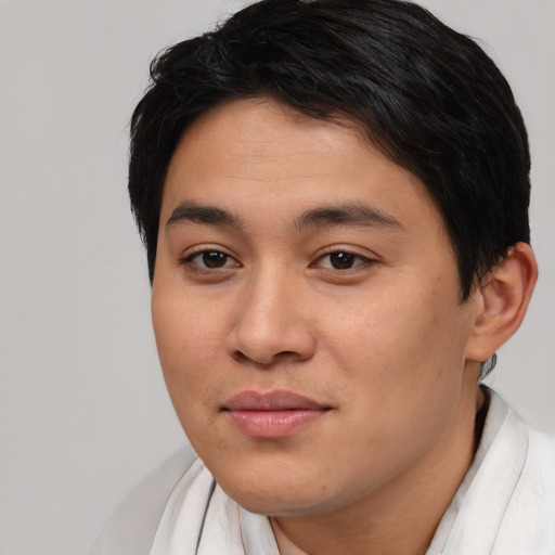 Joyful asian young-adult male with short  brown hair and brown eyes