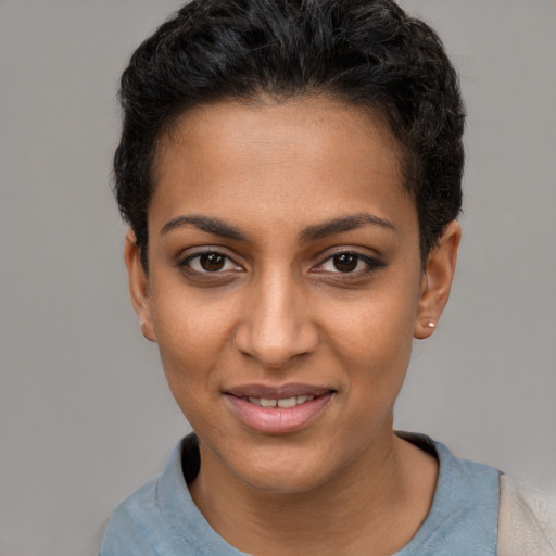 Joyful latino young-adult female with short  black hair and brown eyes
