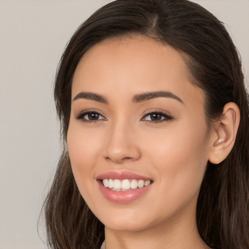 Joyful white young-adult female with long  brown hair and brown eyes