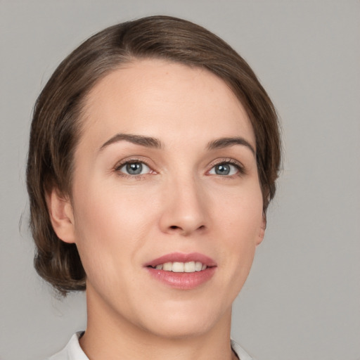 Joyful white young-adult female with medium  brown hair and grey eyes