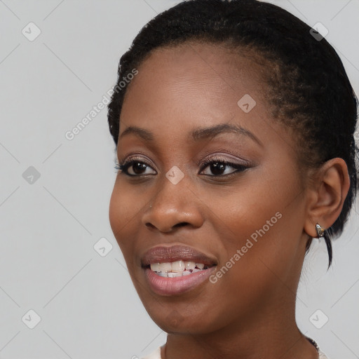 Joyful black young-adult female with medium  brown hair and brown eyes