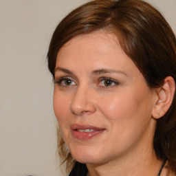 Joyful white adult female with medium  brown hair and brown eyes