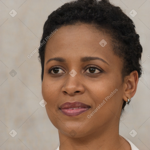 Joyful black young-adult female with short  brown hair and brown eyes