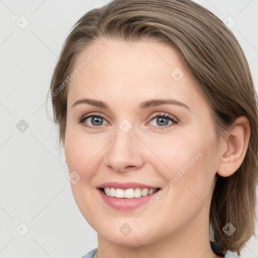 Joyful white young-adult female with long  brown hair and grey eyes