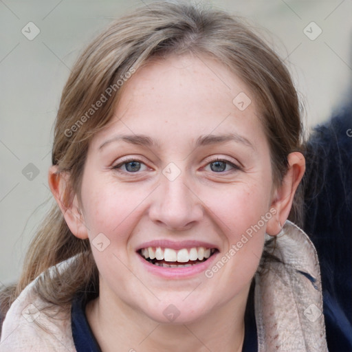 Joyful white young-adult female with medium  brown hair and blue eyes