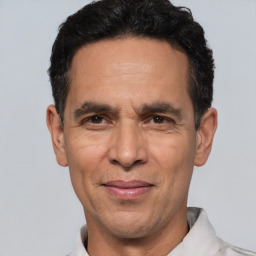 Joyful white adult male with short  black hair and brown eyes