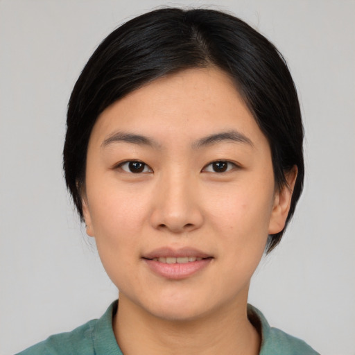 Joyful asian young-adult female with medium  black hair and brown eyes