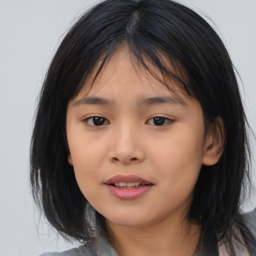 Joyful asian child female with medium  black hair and brown eyes