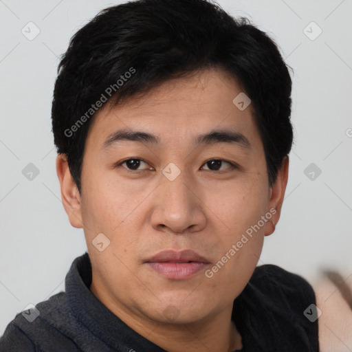 Joyful asian young-adult male with short  brown hair and brown eyes