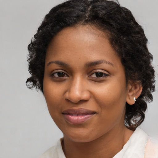 Joyful black young-adult female with medium  brown hair and brown eyes