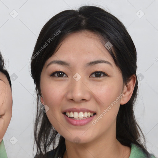 Joyful asian young-adult female with medium  black hair and brown eyes