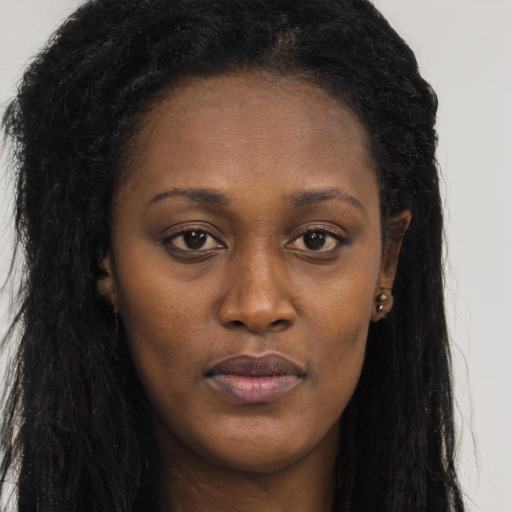 Neutral black young-adult female with long  brown hair and brown eyes