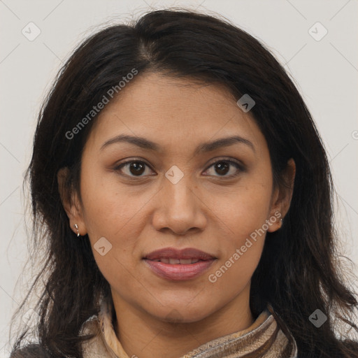 Joyful latino adult female with long  brown hair and brown eyes