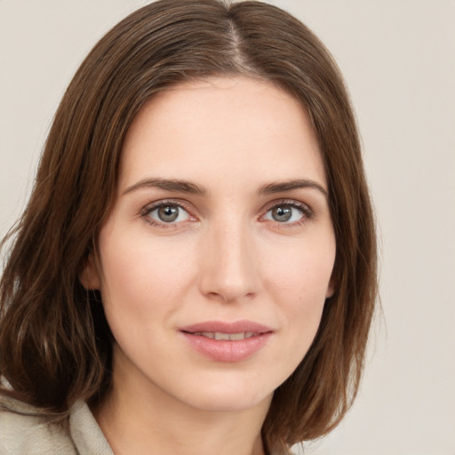 Joyful white young-adult female with medium  brown hair and green eyes