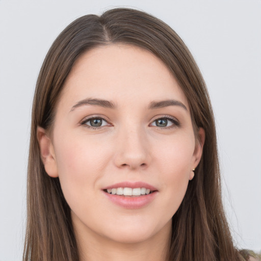 Joyful white young-adult female with long  brown hair and grey eyes