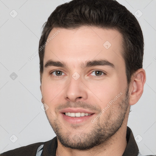 Joyful white young-adult male with short  brown hair and brown eyes