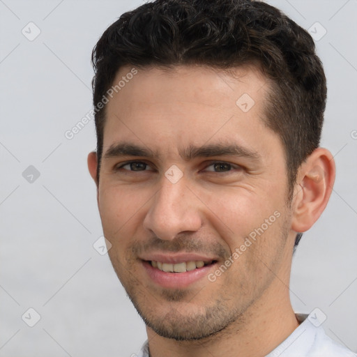 Joyful white young-adult male with short  brown hair and brown eyes