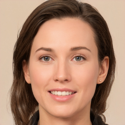 Joyful white young-adult female with medium  brown hair and brown eyes