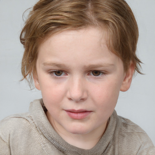 Joyful white child female with short  brown hair and blue eyes