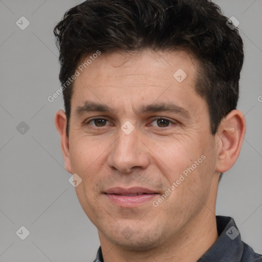 Joyful white adult male with short  brown hair and brown eyes