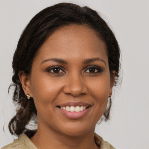 Joyful black young-adult female with medium  brown hair and brown eyes