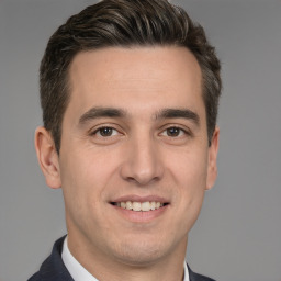 Joyful white young-adult male with short  brown hair and brown eyes