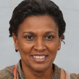 Joyful black adult female with short  brown hair and brown eyes