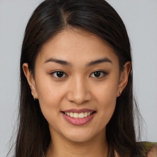 Joyful white young-adult female with long  brown hair and brown eyes