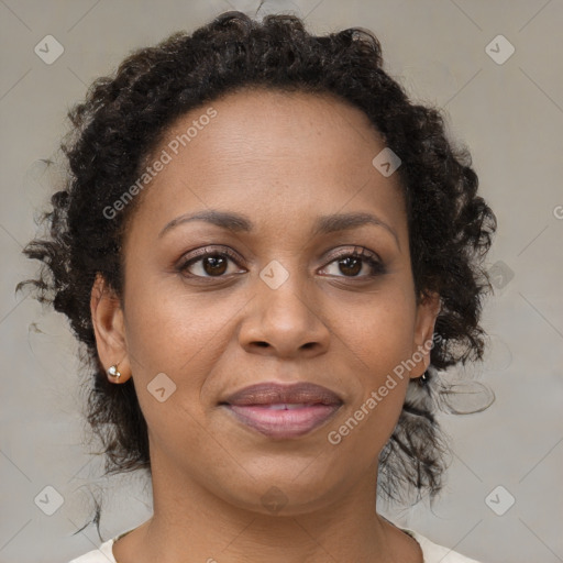 Joyful black adult female with medium  brown hair and brown eyes