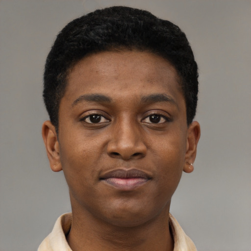 Joyful black young-adult male with short  brown hair and brown eyes