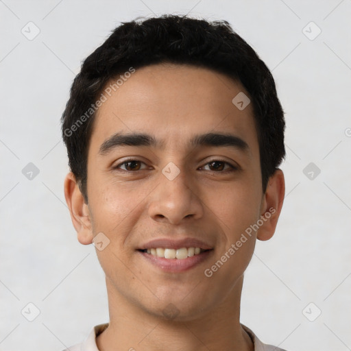 Joyful latino young-adult male with short  black hair and brown eyes