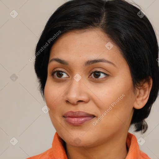 Joyful latino young-adult female with medium  brown hair and brown eyes