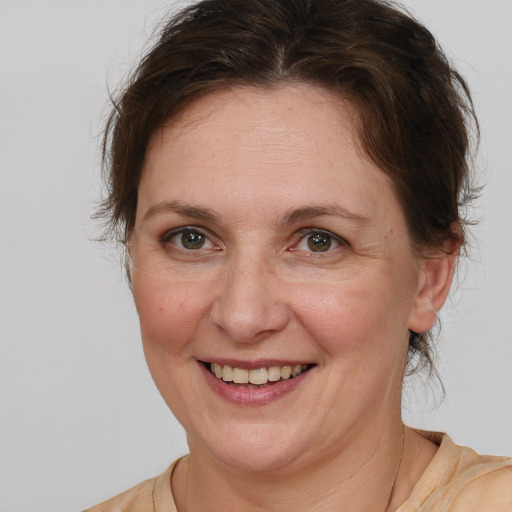 Joyful white adult female with medium  brown hair and brown eyes