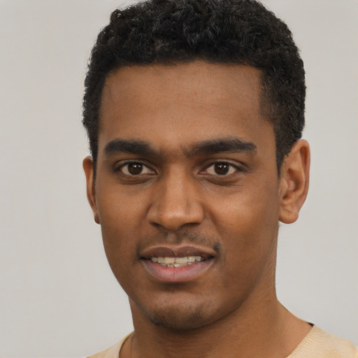 Joyful black young-adult male with short  black hair and brown eyes