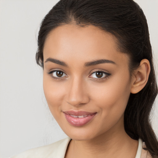 Joyful latino young-adult female with long  brown hair and brown eyes