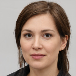 Joyful white young-adult female with medium  brown hair and grey eyes