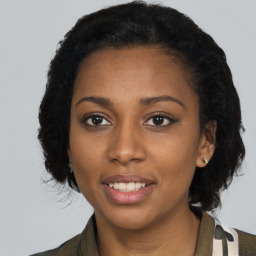 Joyful black young-adult female with medium  brown hair and brown eyes