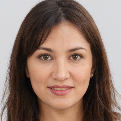 Joyful white young-adult female with long  brown hair and brown eyes