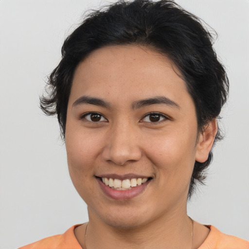 Joyful asian young-adult female with short  brown hair and brown eyes