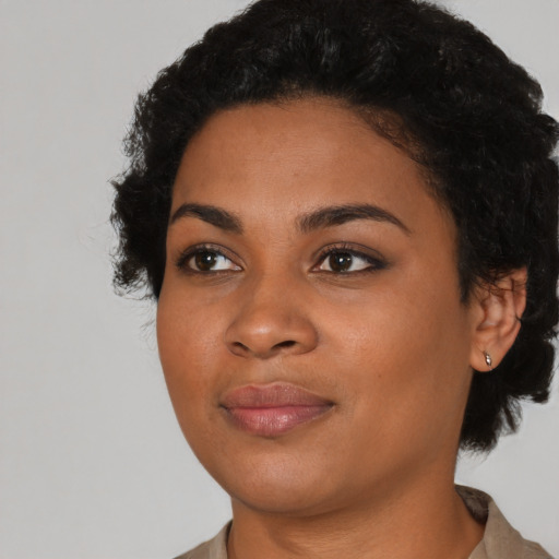 Joyful latino young-adult female with short  black hair and brown eyes