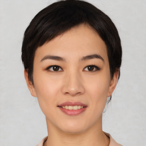 Joyful asian young-adult female with short  black hair and brown eyes