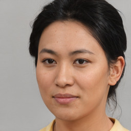 Joyful asian young-adult female with medium  brown hair and brown eyes