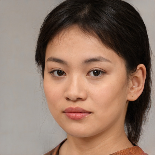Joyful asian young-adult female with medium  brown hair and brown eyes