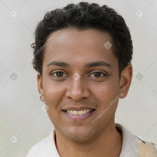 Joyful black young-adult male with short  brown hair and brown eyes