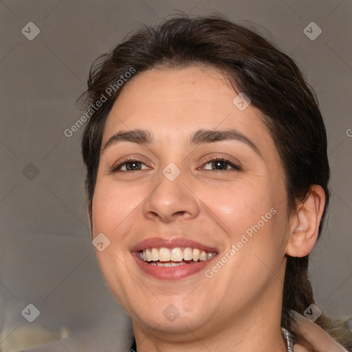 Joyful white adult female with medium  brown hair and brown eyes