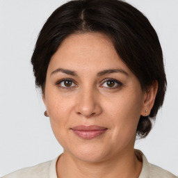 Joyful white adult female with medium  brown hair and brown eyes