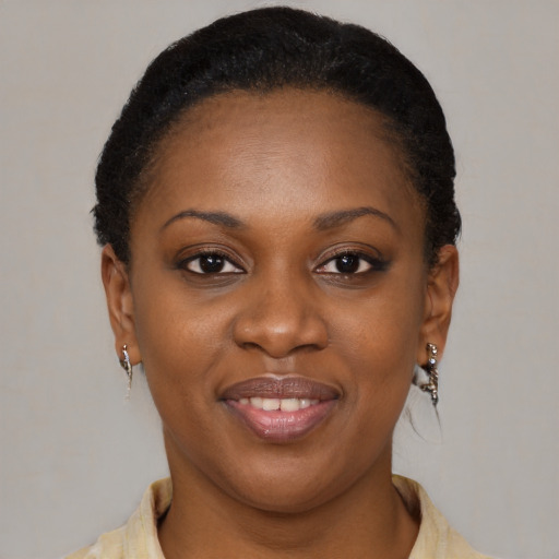 Joyful black young-adult female with short  brown hair and brown eyes