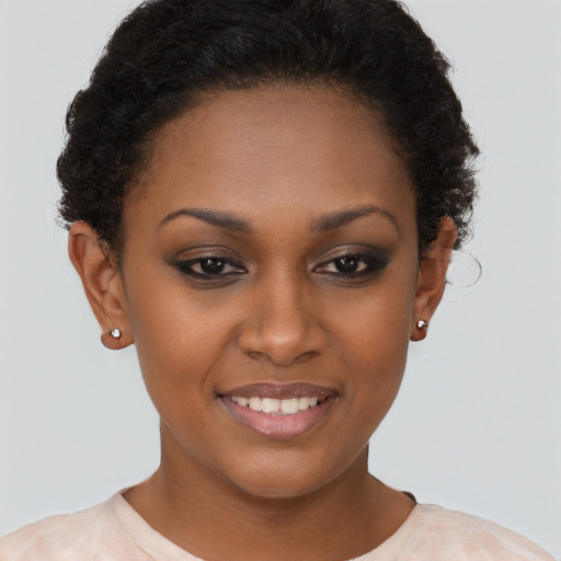 Joyful black young-adult female with short  brown hair and brown eyes
