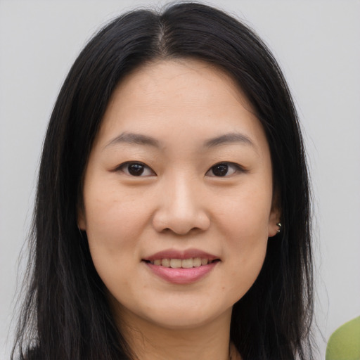 Joyful asian young-adult female with long  brown hair and brown eyes